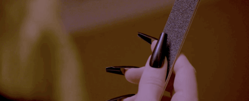 Image of a hand holding an emory board from the short film Manicured